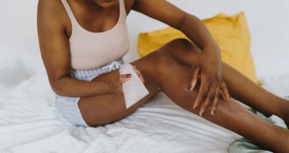 Person applying cream to their leg