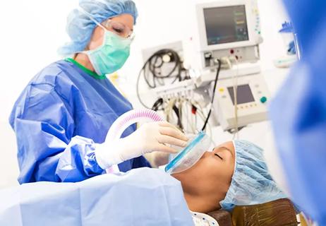 Patient being sedated by anesthesiologist before surgical procedure