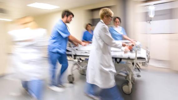 medical team rushing patient on gurney through hospital hallway