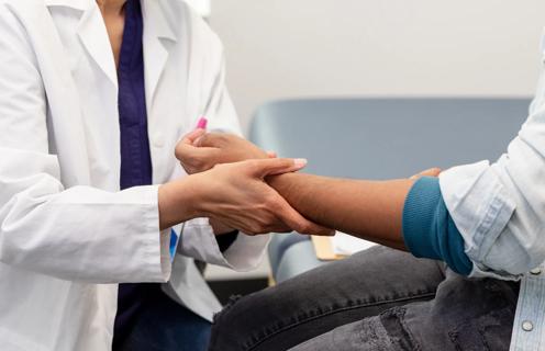 Healthcare provider examining patient's wrist