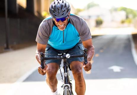 happy man biking through city exercise