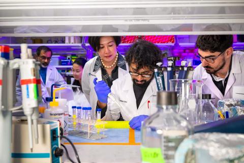 Researchers standing in laboratory