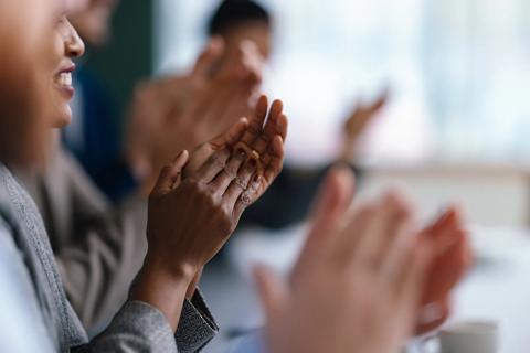 The word Kudos surrounded by stars