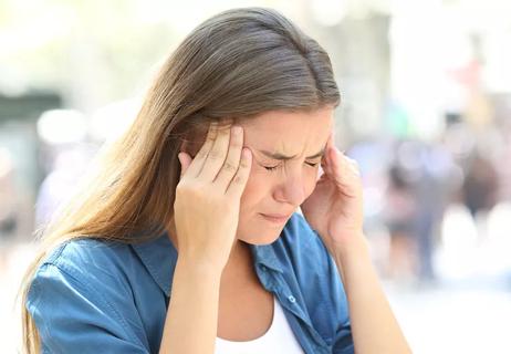 Woman experiencing a cluster headache