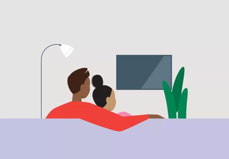Couple sitting on sofa watching TV