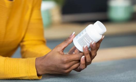 Person examining bottle of pills