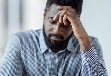 Man holding head looking worried or depressed.