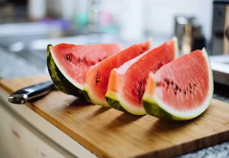Slices of watermelon on kitchen counter.