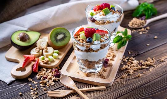 Yogurt, granola, fruit parfatis, with fruit on cutting boards