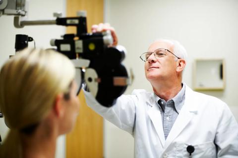 Eye doctor giving a patient an eye exam