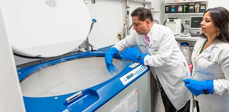Drs. Agarwal and Gupta in their lab. This LN2 storage tank contains semen samples preserved in cryoprotective media at -196ºC for long-term storage.