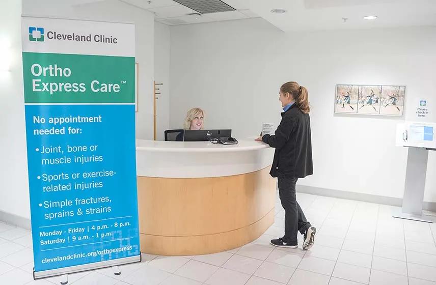 Women talking at ortho express care reception desk