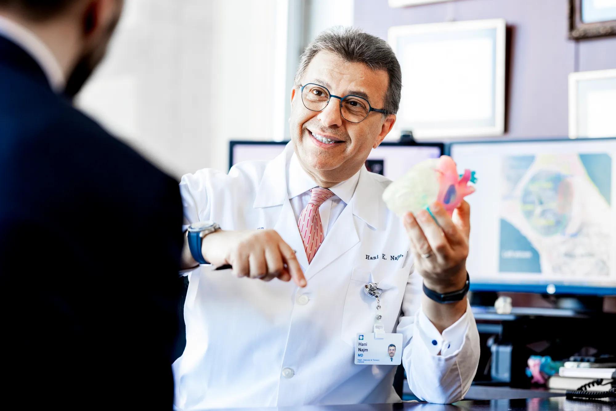 Cardiologist Dr Hani Najm holding a plastic heart model