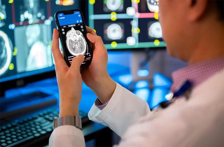 A man holding a mobile device with a stroke detection app on the screen