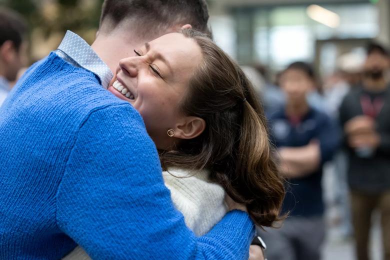 CCLCM students excitedly hugging.
