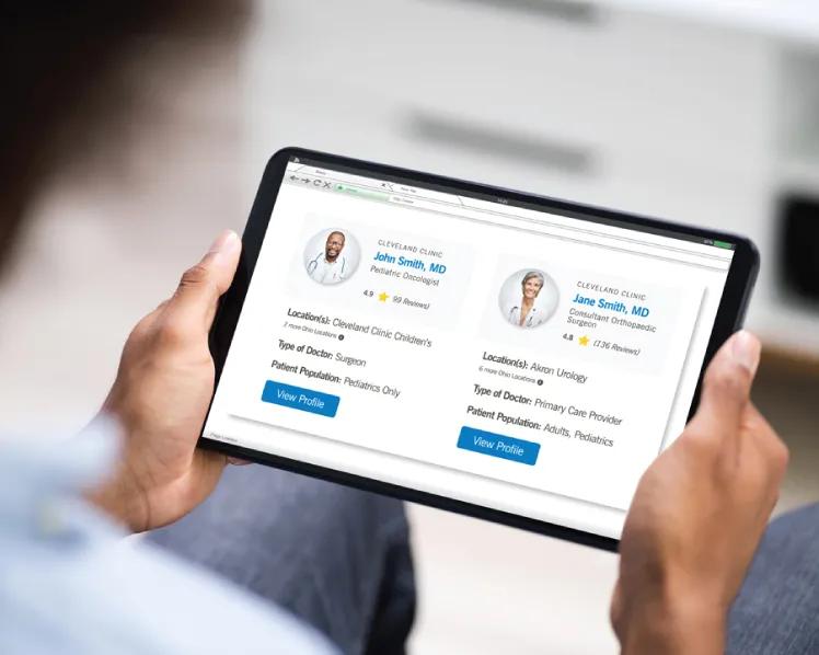 Person holding tablet looking at Cleveland Clinic provider profiles