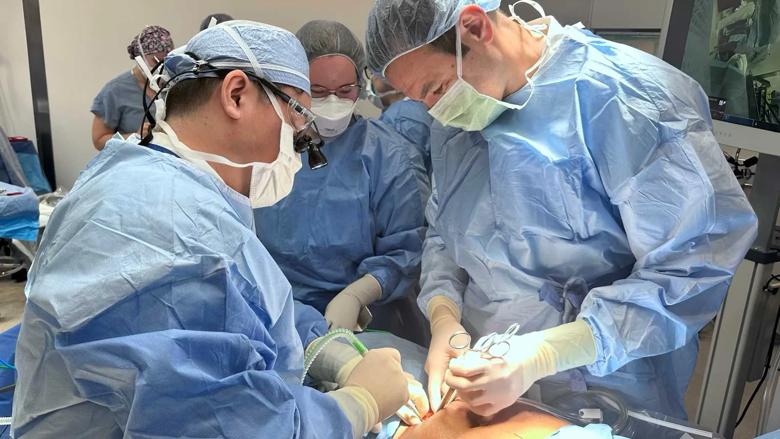 Surgeons prepare the transplant recipient