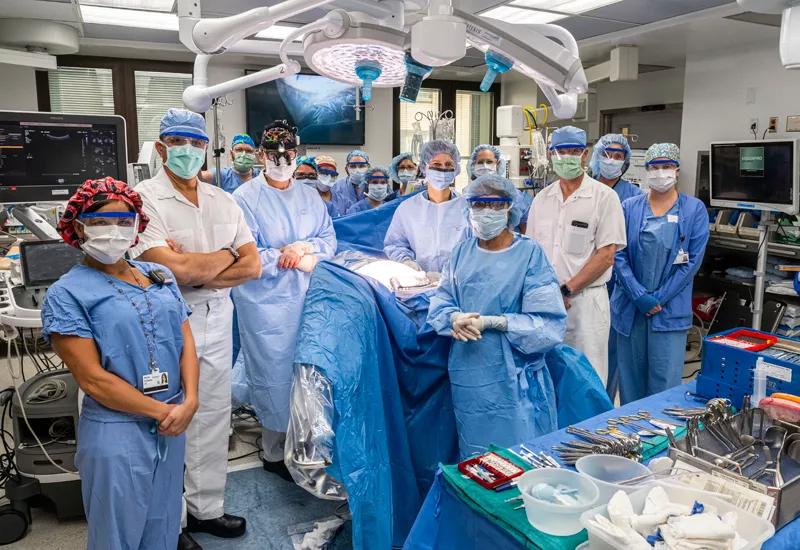 Members of the surgical team pose after the operation ends.