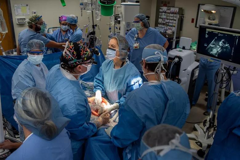 As Dr. Kalan operates the ultrasound transducer, Dr. Cass watches to note the placenta’s location and the fetus’s position.