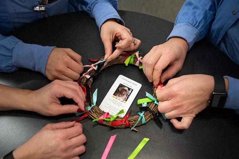 Hands making wreath