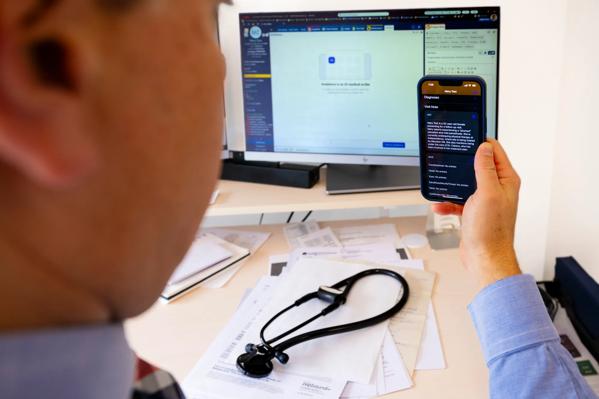 Eric Boose, M.D., uses AI software to document a patient appointment.