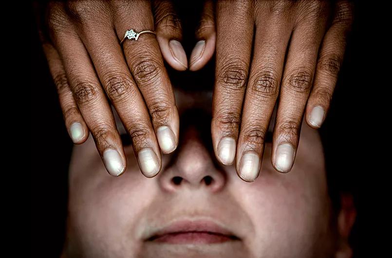 Hands over face