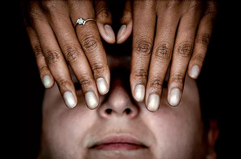 Hands over face