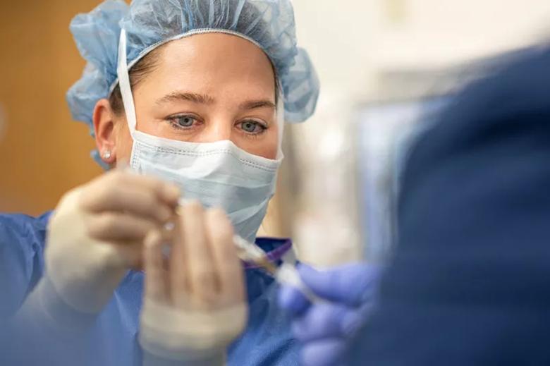 Nurse preparing fluid for injection