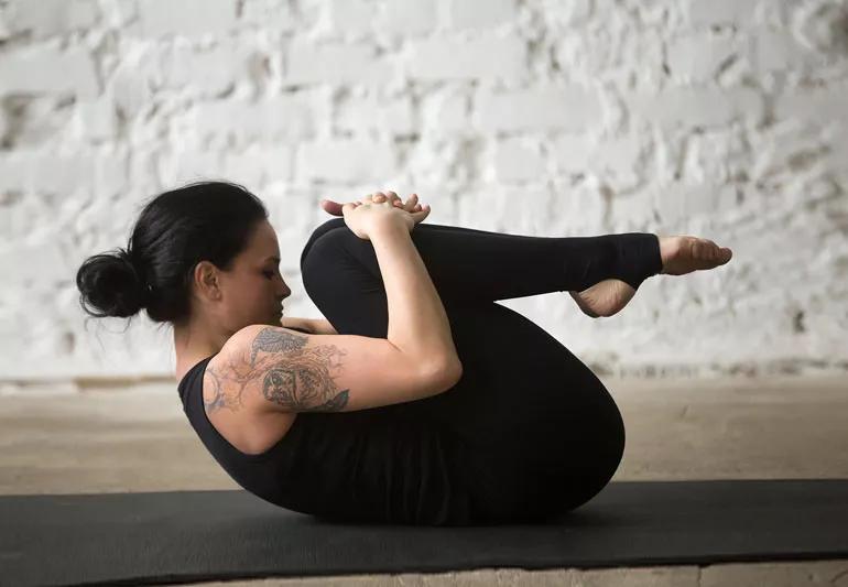 woman practicing yoga before bed