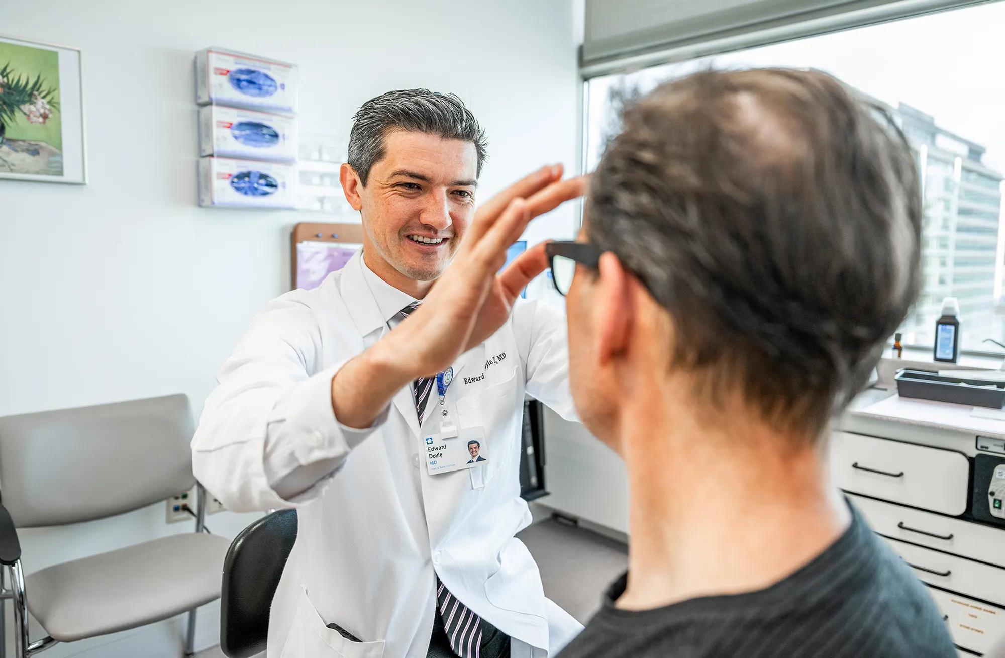Edward Doyle, MD examining a patient