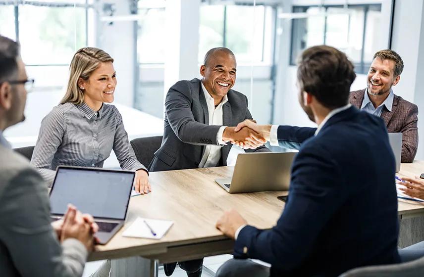 Group of professionals around a table in a conference room.