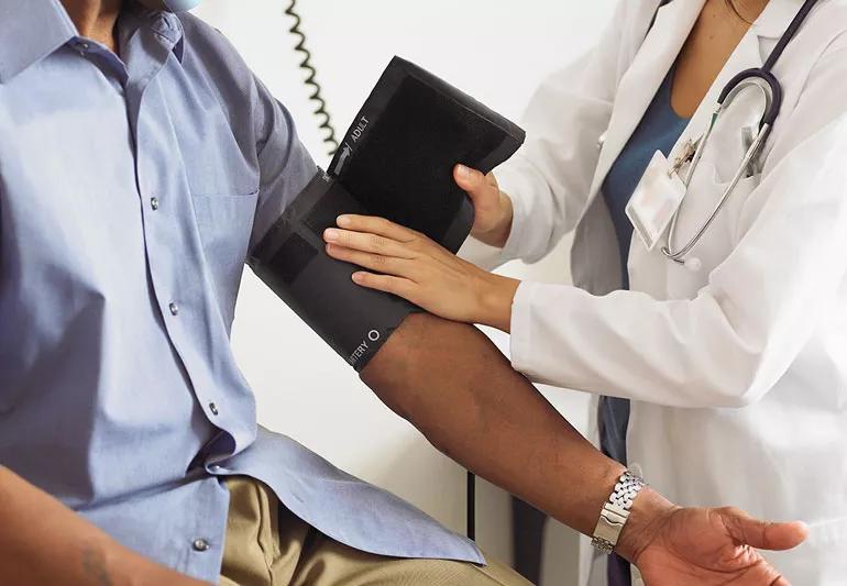 Patient being examined for their blood pressure in a clinical setting.