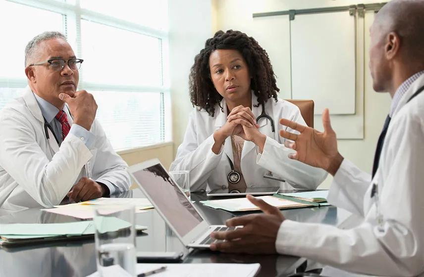 Doctors discussing around a table