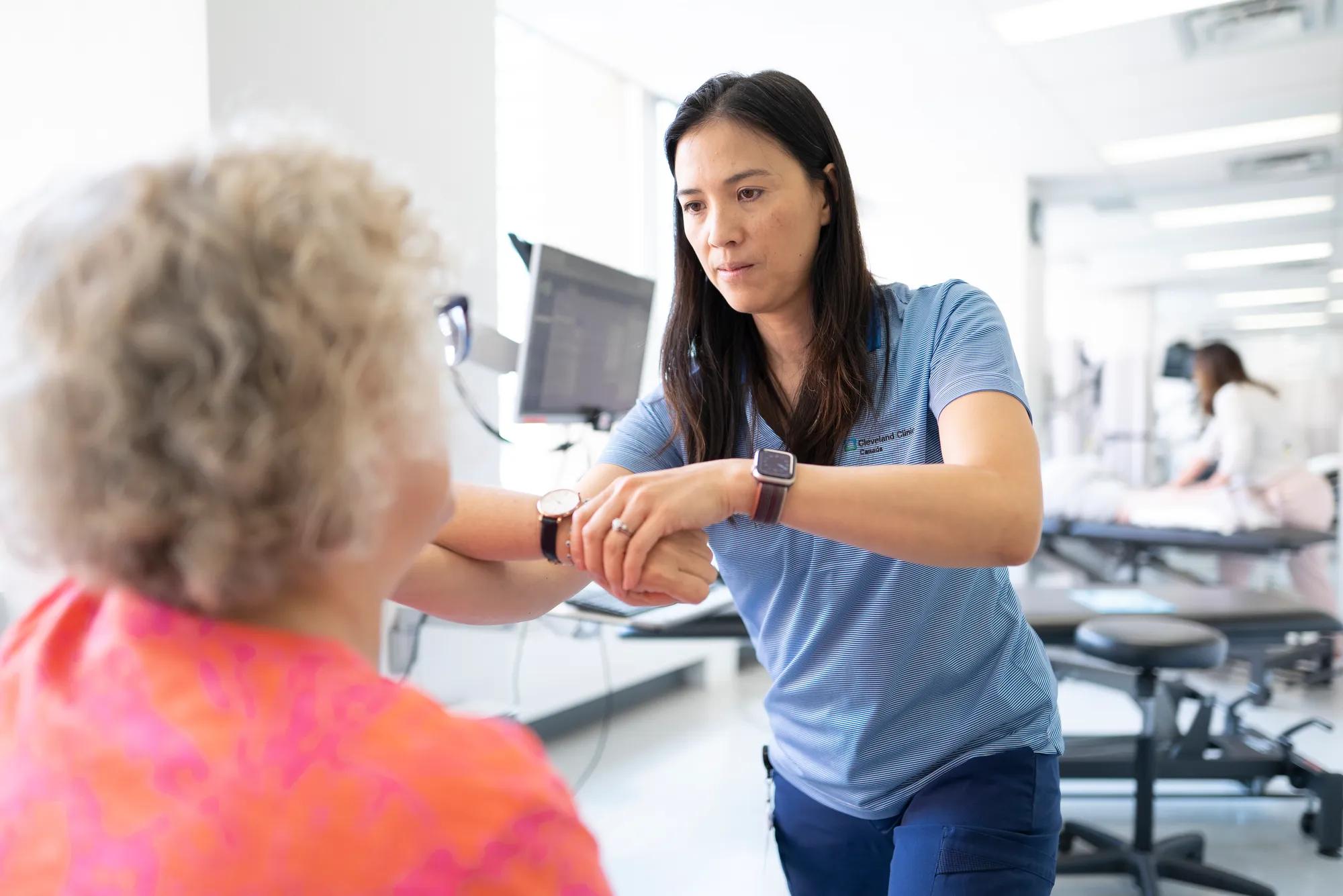 Patient having her arm looked at by provider