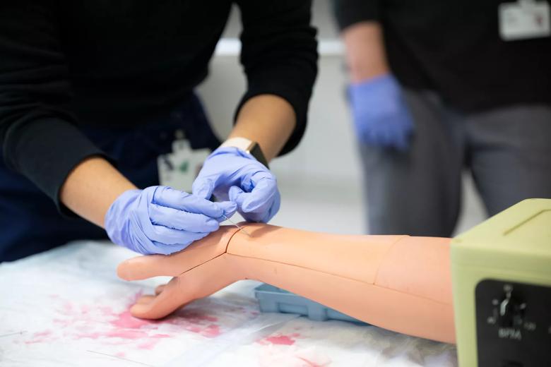 Students performing medical simulations in preparation for residency.